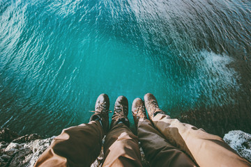 Couple feet above sea on cliff Love and Travel happy emotions Lifestyle concept aerial view