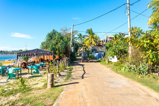 The Vijaya Road at the beachside of the coastal town Tangalle in the south east of Sri Lanka. The small road leads along the Medaketiya beach and runs to the Rekawa lagoon