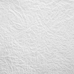 White crumpled paper background.