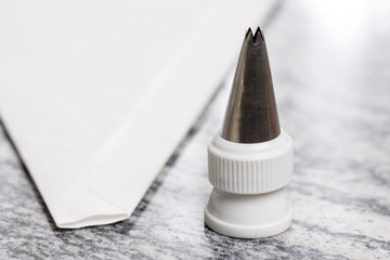 White pastry piping bag on the grey granite background table