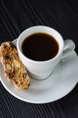 Cup of black coffee with cantuccini