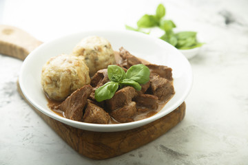 Traditional homemad beef goulash with dumplings