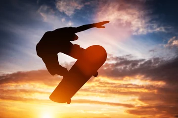 Fotobehang Skateboard Skateboarder jumping at sunset.  © Photocreo Bednarek