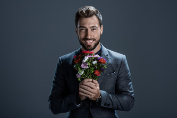 Handsome man holding bouquet