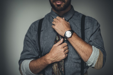 man adjusting tie - Powered by Adobe