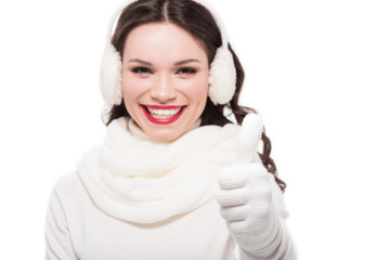 Woman in earmuffs showing thumb up