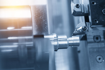 CNC lathe machine (Turning machine) cutting the metal  screw thread part by lathe cutter .Hi-precision CNC machining concept.