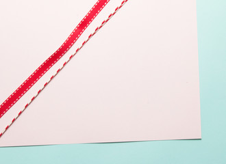 Red ribbon on paper background