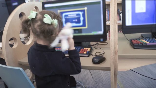 Little girl playing educational games on the computer