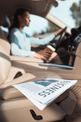 business newspaper in car