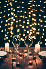 wineglasses on table with candles