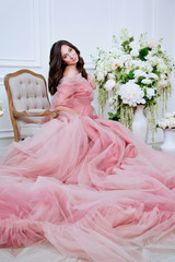Fototapeta premium beautiful girl in pink dress with white flowers