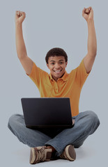Happy african american man working on laptop.