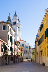 Fototapeta na wymiar Venecian cityscape with colorful houses and church. Italy