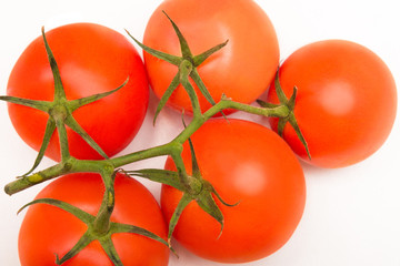 Fototapeta na wymiar Tomatoes weighing on a branch
