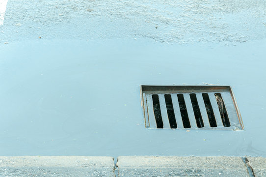 Street drainage manhole with water after rain going in 