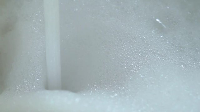 Water and foam in bath slowmotion