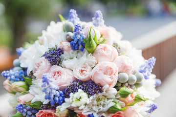 Bridal bouquet with roses, brunia and Muscari flowers. Traditional accessory for wedding.