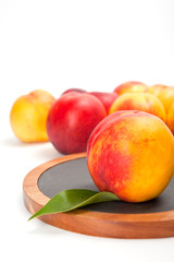 Freshly washed peach  on wooden cutting board isolated on white background
