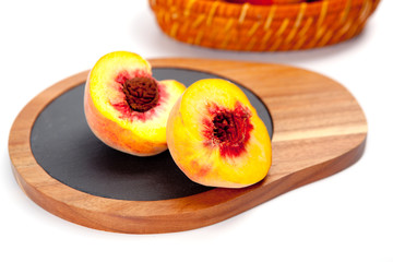 Freshly washed peach  on wooden cutting board isolated on white background