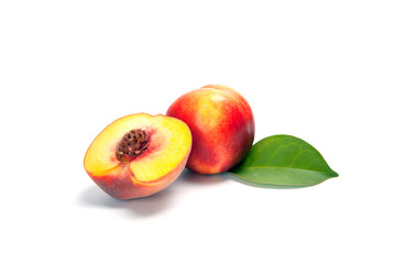 One and a half nectarine peaches isolated on white background