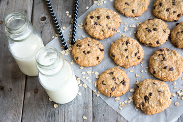 oatmeal cookies with chocolate on an old wooden background