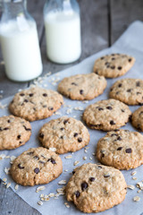 oatmeal cookies with chocolate on an old wooden background