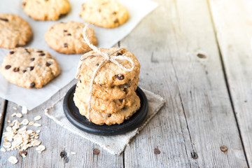 oatmeal cookies with chocolate on an old wooden background