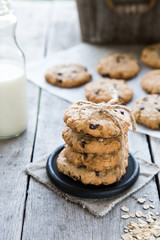 oatmeal cookies with chocolate on an old wooden background