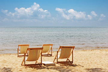 Beach chairs on idyllic tropical sand beach.