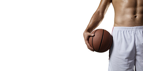 Basketball player hold a basketball ball. Isolated basketball player on a white background. Basketball player with a naked torso and pumped muscles. Player wears unbranded clothes.