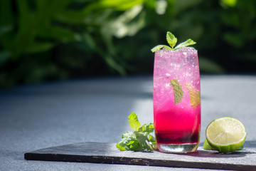 Red mocktail with lime and mint.