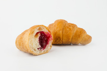 Delicious croissants with cherry jam on a white background