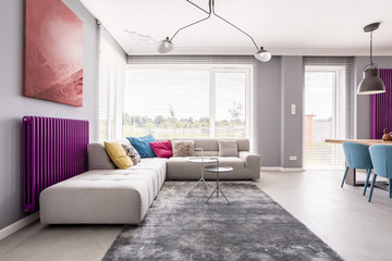 Abstract painting hanging above sofa
