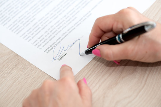Woman signing a contract