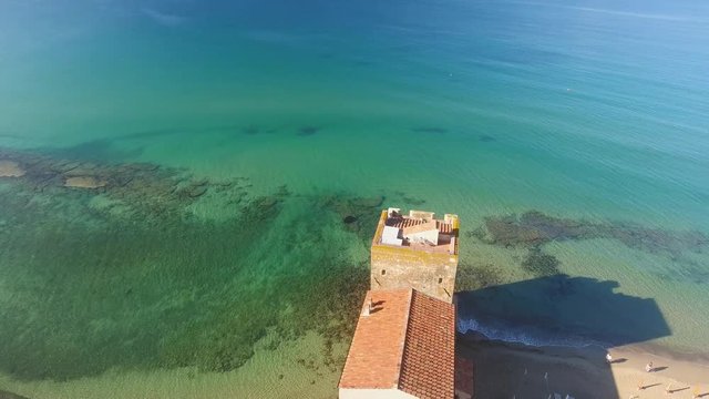 Orbit around the tower over the sea, Torre Mozza, Italy.