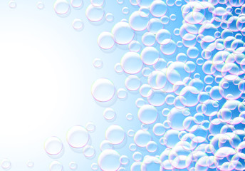Soap bubbles abstract blue background with rainbow colored airy foam