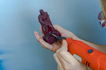 The figure of a knight from a tree. Grinding drill for jeweler. Milling of a wooden handmade figurine with a milling cutter and a router.