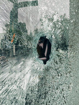 Hole in broken shattered glass window