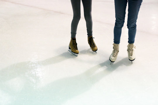 The Legs Of Two Girls Ice Skating