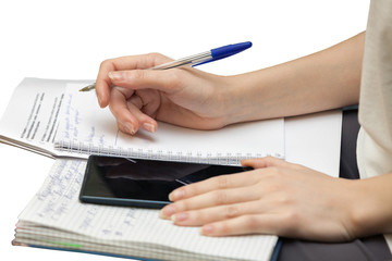 Fototapeta premium Female hands write in diary isolated