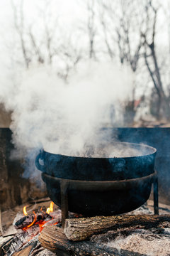 Cooking food on an open fire in a kettle outside