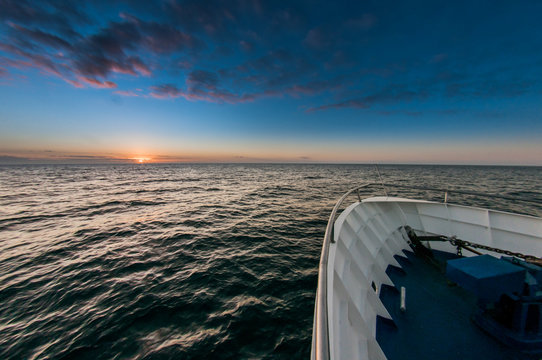 Boat Bow and sunset over ocean