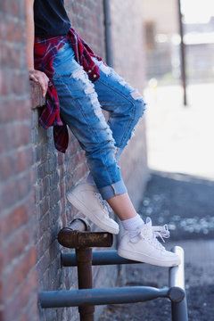 young woman's legs stretched out from edge of opening
