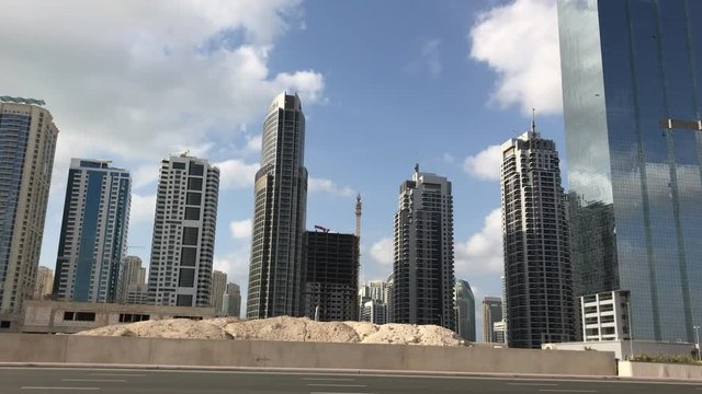 DUBAI, UAE - DECEMBER 2016: City traffic on a sunny day from a moving car. Dubai suffers heavy car traffic.