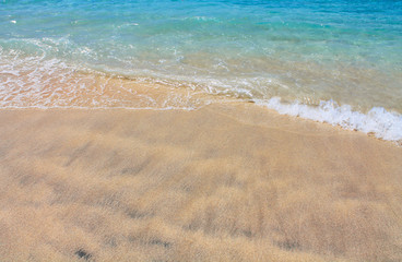 Sand and blue sea, Waves breaking on beach.