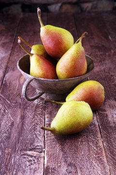 Fresh ripe organic pears on rustic wooden table, natural background, vega, diet food