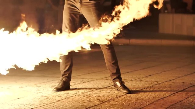 Young peoples dances with fire in the night