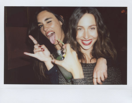 two young women making faces