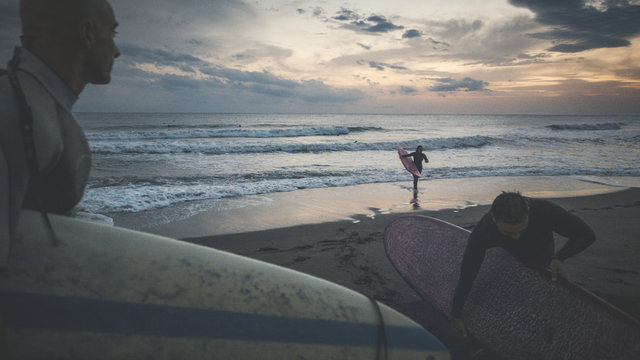 Surfers coming out from water after a surf session